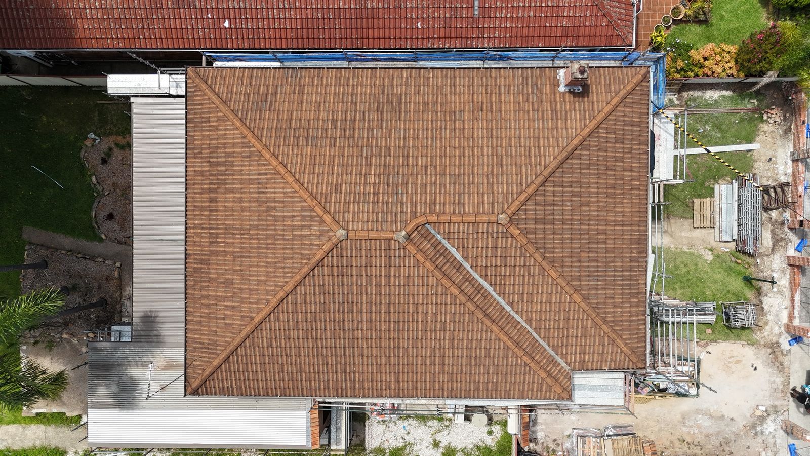 Strathfield roof restoration from the drone, terracotta to charcoal, before